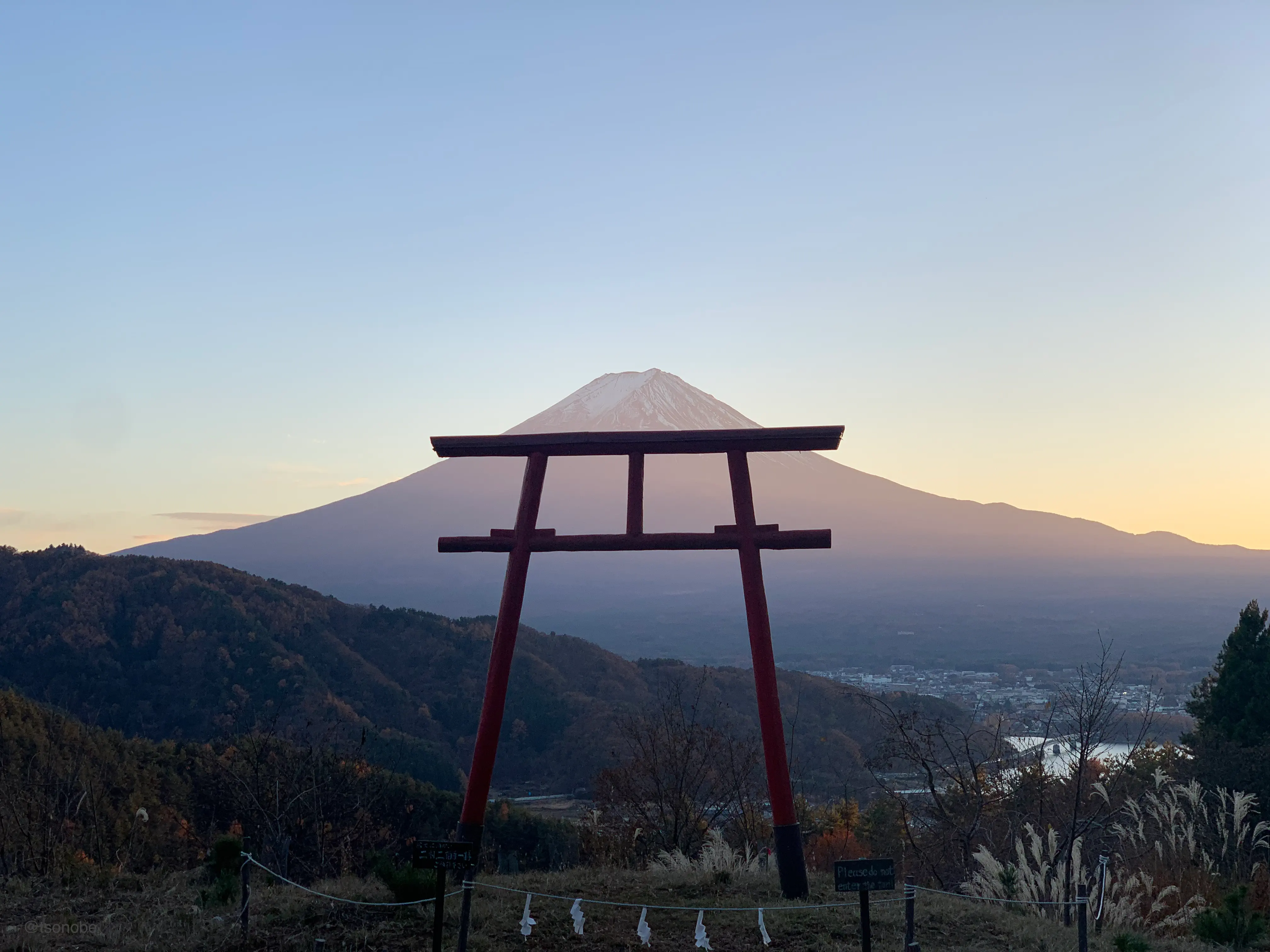 Sunrise view of Mt. Fuji behind a torii gate